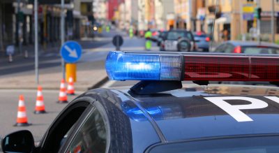 Blue sirens of police car during the roadblock in the city